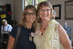 Painters Embrace: Longtime Expressive Arts Institute friend and Swift Gallery Artist Ellen Dieter (l) and first class graduate Pamela Underwood light up the party.